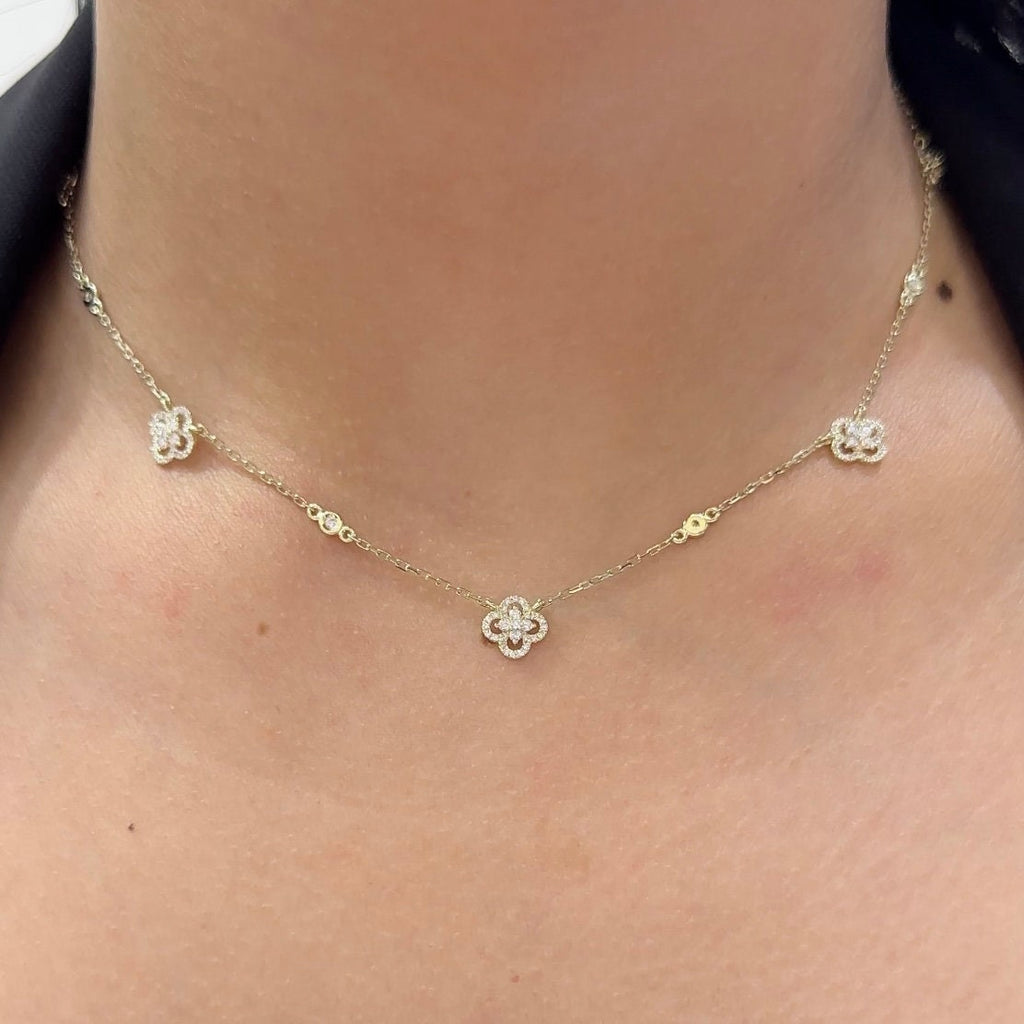Woman wearing yellow gold diamond by the yard clover necklace