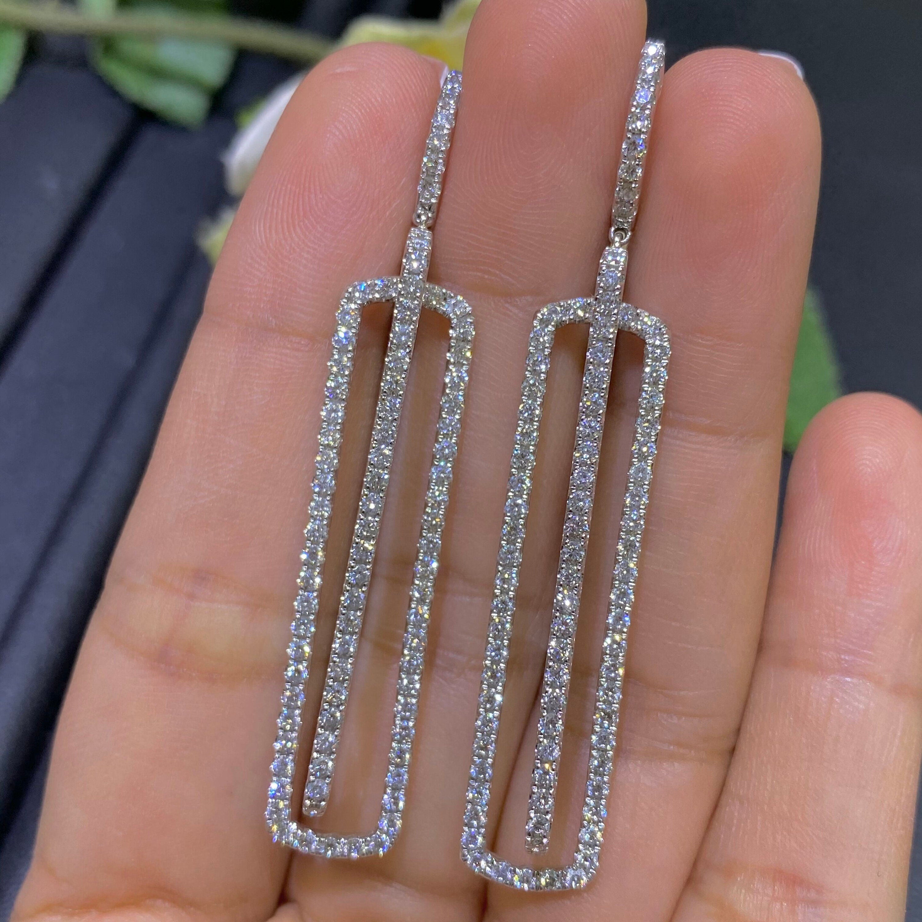 Woman holding white gold double rectangular drop diamond earrings. (etsy image id: 4013008622)