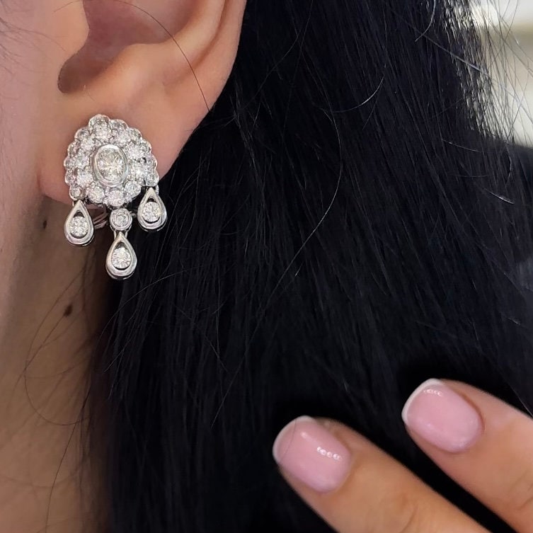 White Gold Hanging Earrings with a Oval Cut Center Stone Diamond and Surrounding Round Cut Diamonds (etsy image id: 4776913126)