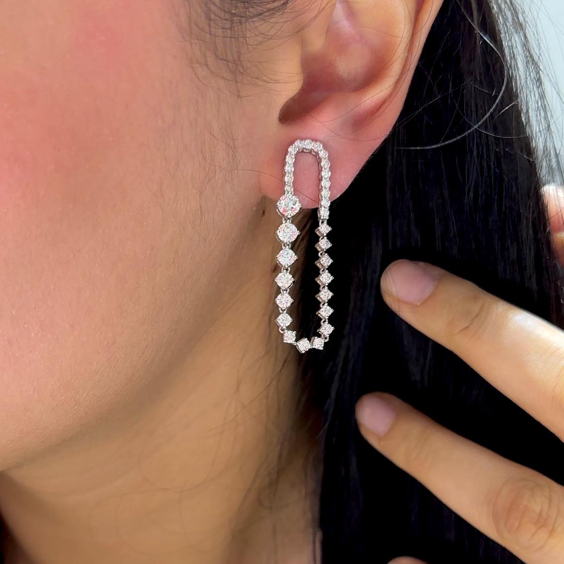 Woman wearing elongated dangle diamond earrings (etsy image id: 6698294958)