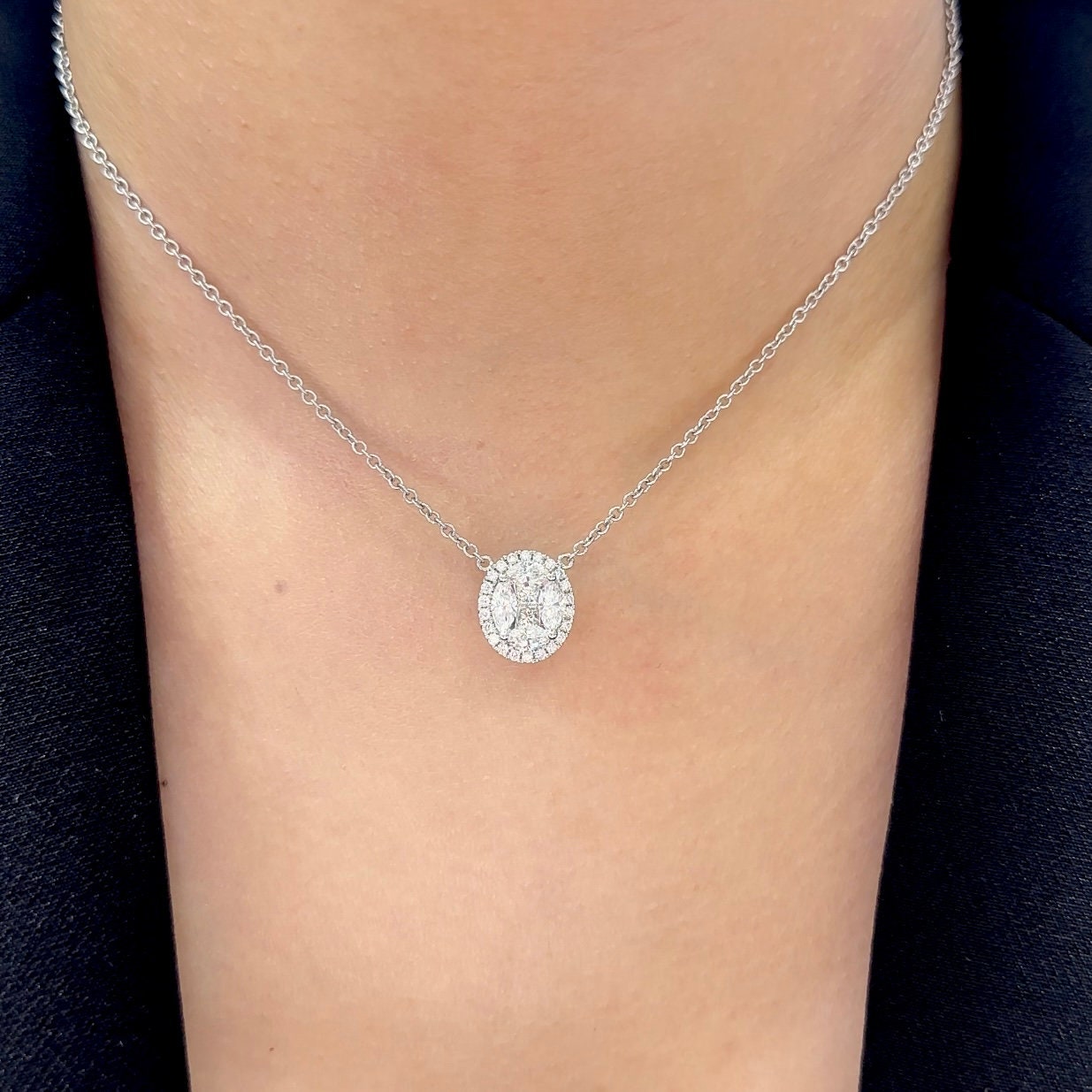 Woman wearing a white gold diamond pendant in a halo setting (etsy image id: 6722733936)