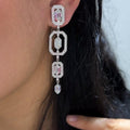 Woman wearing elongated dangling Art Deco style earrings  featuring lab diamonds (etsy image id: 6746101969)