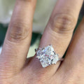 Woman wearing natural marquise shape diamond ring with cadillac shape diamonds on each side. (etsy image id: 6746124463)