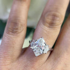 Woman wearing natural marquise shape diamond ring with cadillac shape diamonds on each side. (etsy image id: 6746124463)