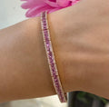Woman wearing a pink sapphire and diamond bracelet. (etsy image id: 6753230859)