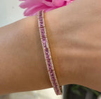 Woman wearing a pink sapphire and diamond bracelet. (etsy image id: 6753230859)