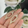 Woman holding yellow gold Art Deco style drop earrings (etsy image id: 6755542427)