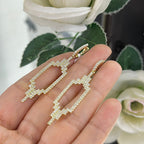 Woman holding yellow gold Art Deco style drop earrings (etsy image id: 6755542427)