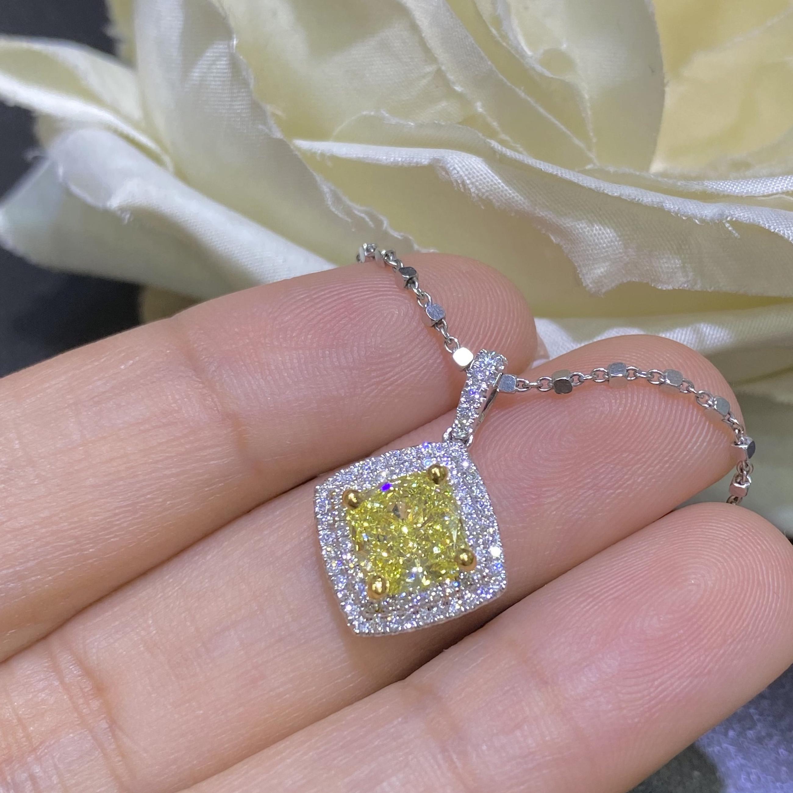 Woman holding a white gold necklace with yellow diamond center and surrounded by white diamonds. (etsy image id: 6757967548)
