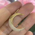 Woman holding yellow gold moon pendant with bottom half of the moon in pave diamonds (etsy image id: 6765438262)