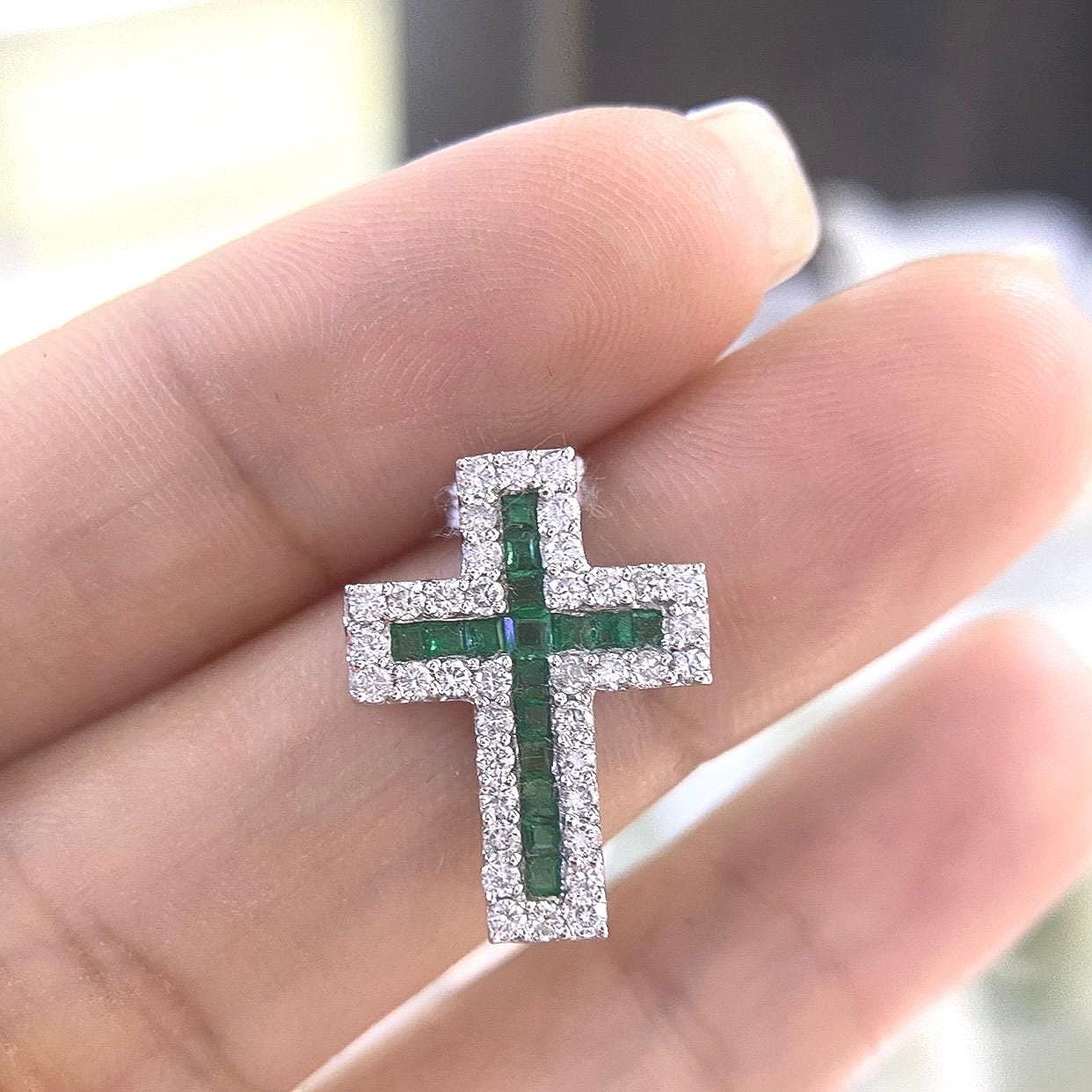 Woman holding a white gold Diamond and Emerald Gemstone cross. (etsy image id: 6765720052)