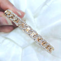 Woman holding yellow gold chain link solid bangle with diamonds. (etsy image id: 6768058668)