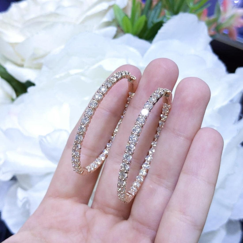 Woman holding Rose Gold Hoop Earrings with inside out diamonds (etsy image id: 6768149102)