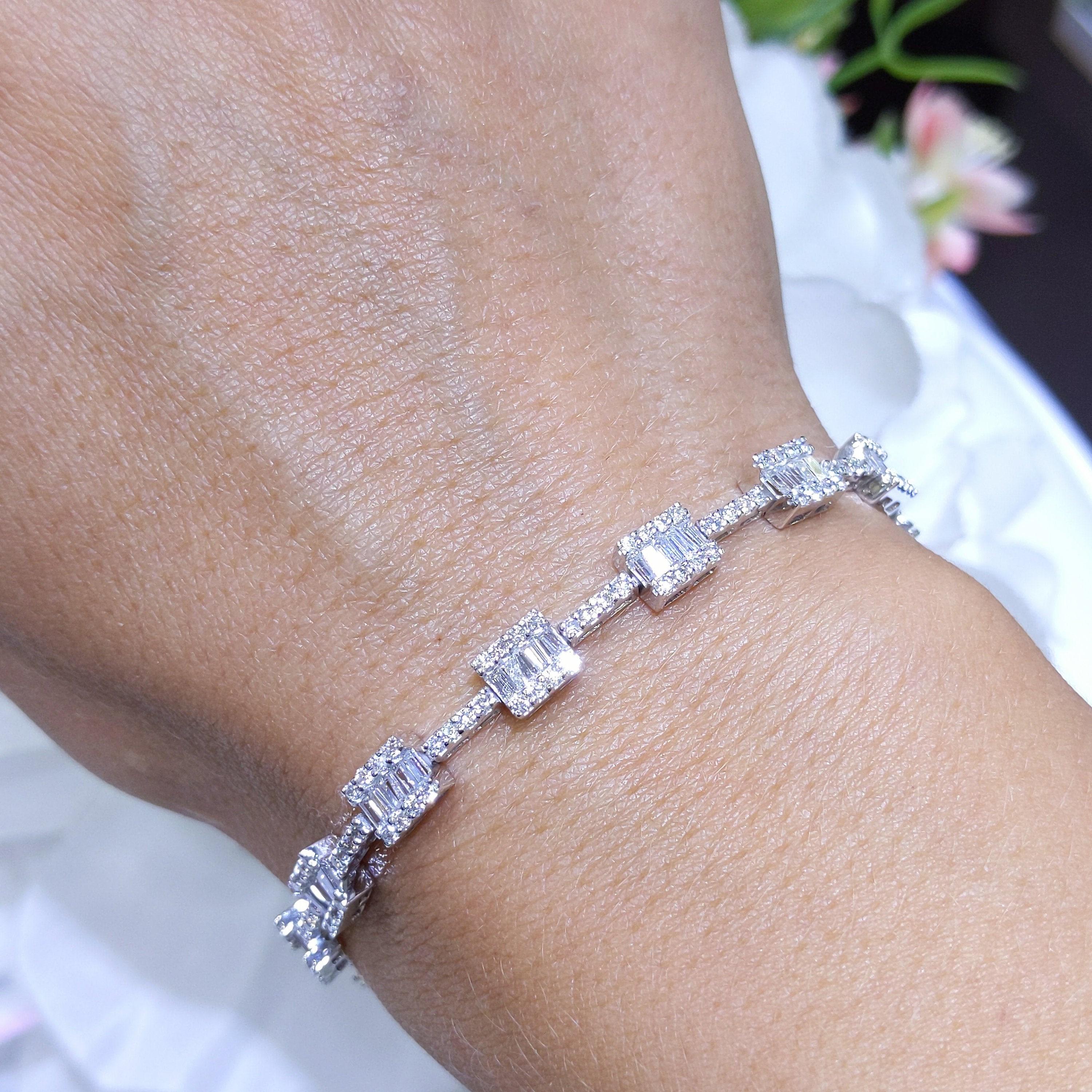 Woman wearing a white gold tennis bracelet with round cut and baguette cut diamonds. (etsy image id: 6768178672)