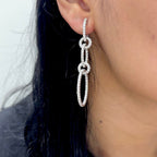 Woman wearing dangling 5 circle diamond earring (etsy image id: 6771006249)
