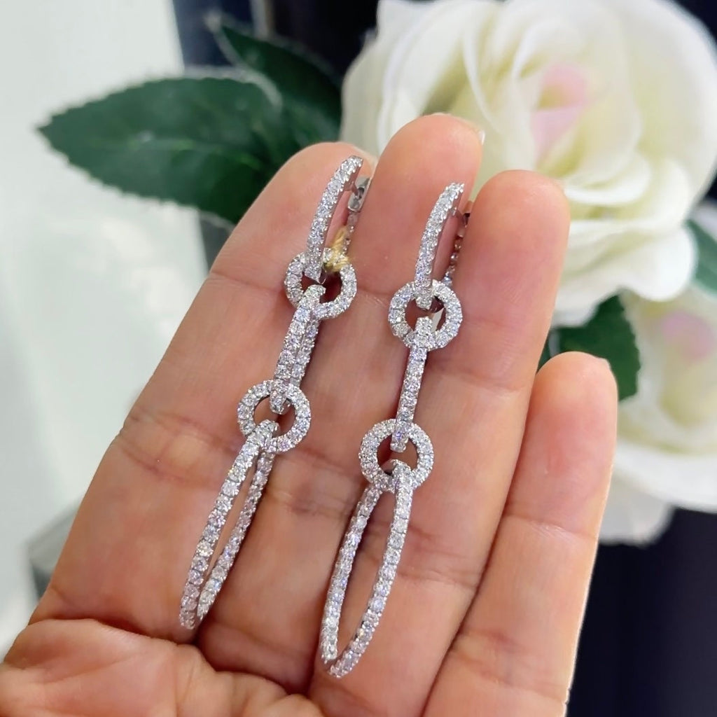 Woman holding 5 circle dangling diamond earrings (etsy image id: 6771009975)