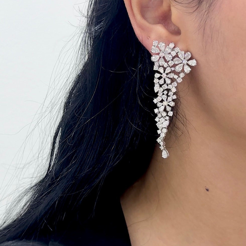Woman wearing flower clusters diamond drop earrings (etsy image id: 6771283805)