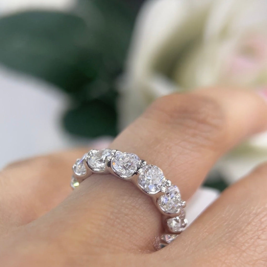 Woman wearing full circle eternity band ring in white gold (etsy image id: 6776489407)