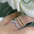 Woman wearing three stacking wave rings. Rings are yellow, rose and white gild with diamonds (etsy image id: 6779014469)