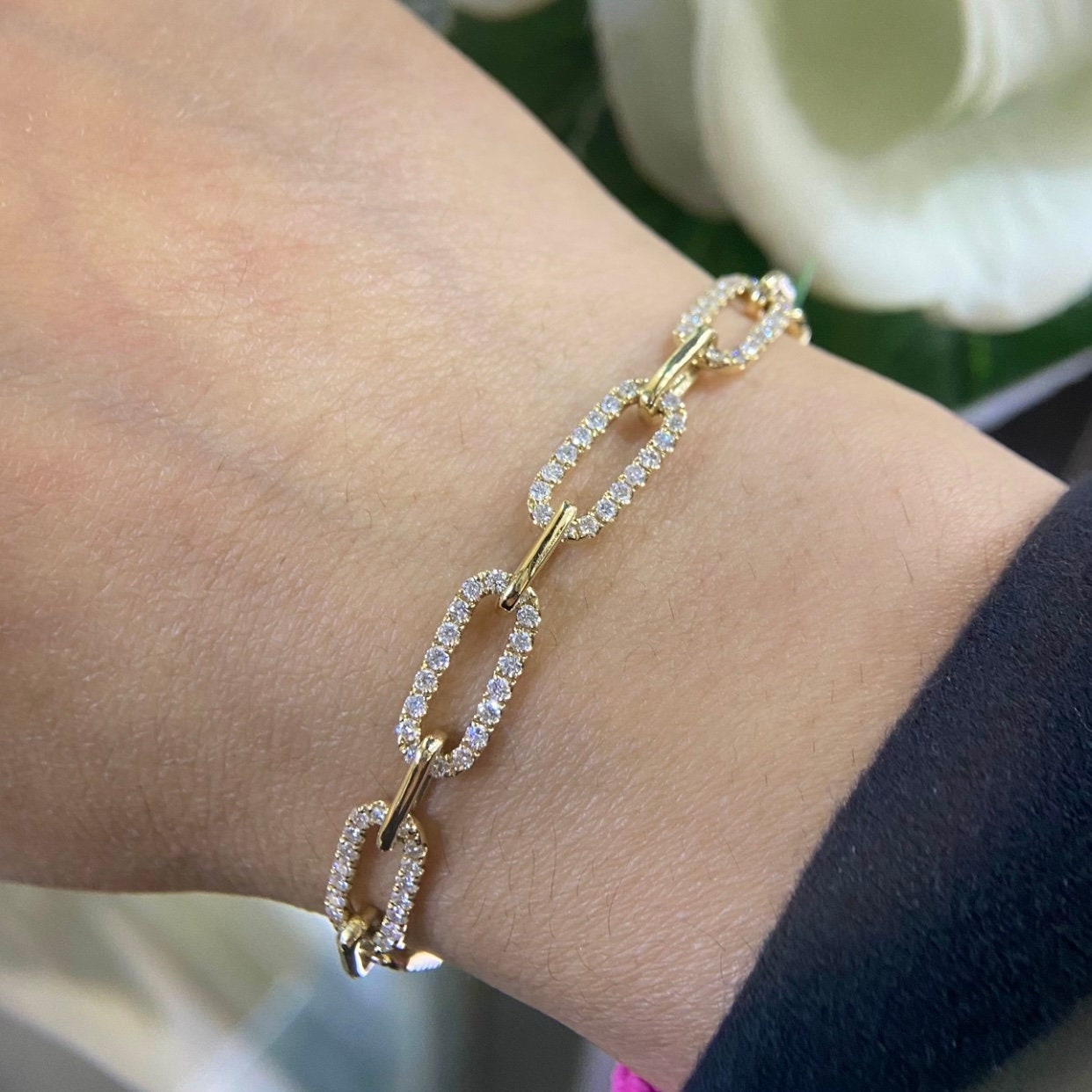 Woman wearing yellow gold paperclip link bracelet with diamonds (etsy image id: 6781590009)