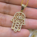 Woman holding yellow gold diamond encrusted Hamsa pendant (etsy image id: 6788917333)