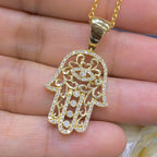 Woman holding yellow gold diamond encrusted Hamsa pendant (etsy image id: 6788917333)