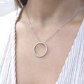 Woman wearing white gold necklace with a diamond circle pendant (etsy image id: 6816025777)