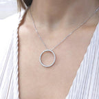 Woman wearing white gold necklace with a diamond circle pendant (etsy image id: 6816025777)
