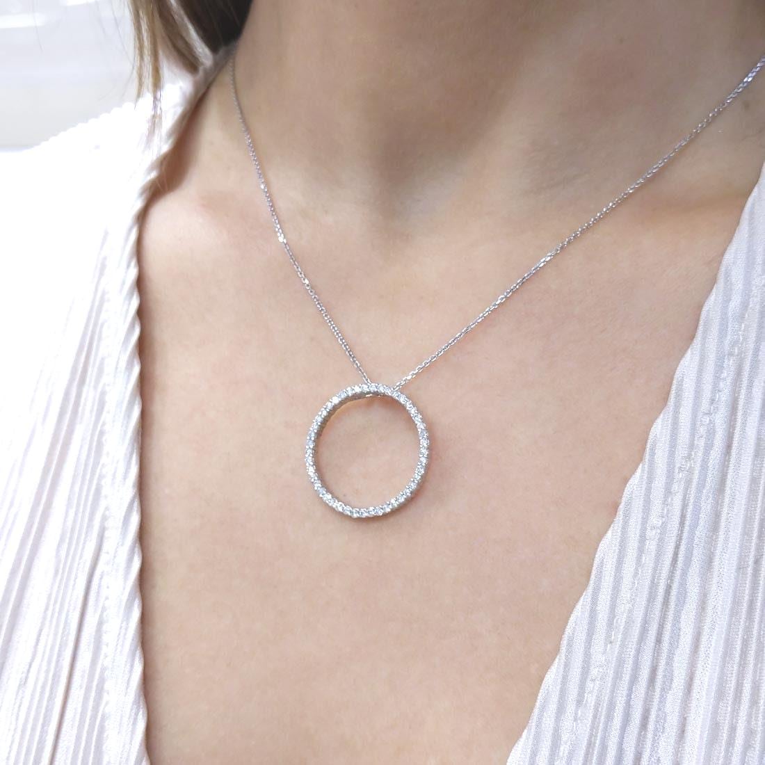 Woman wearing white gold necklace with a diamond circle pendant (etsy image id: 6816025777)