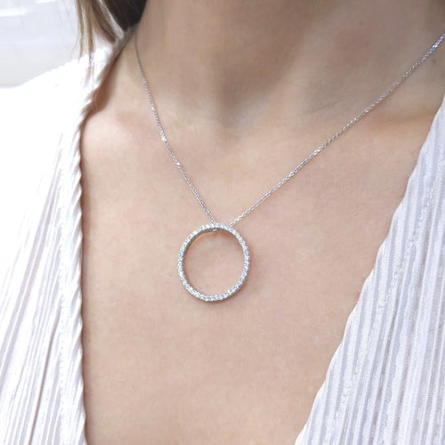 Woman wearing white gold necklace with a diamond circle pendant (etsy image id: 6816025777)