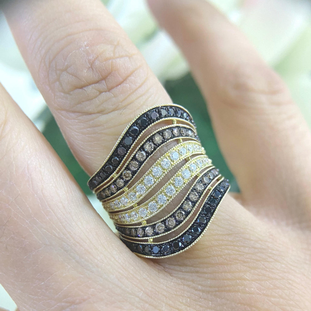 Woman wearing 6 row gold ring with black and white diamonds. Top two rows are black rhodium, middle two rows are yellow gold and bottom two rows are black rhodium. Top and bottom row of ring have black diamonds. (etsy image id: 6822514787)