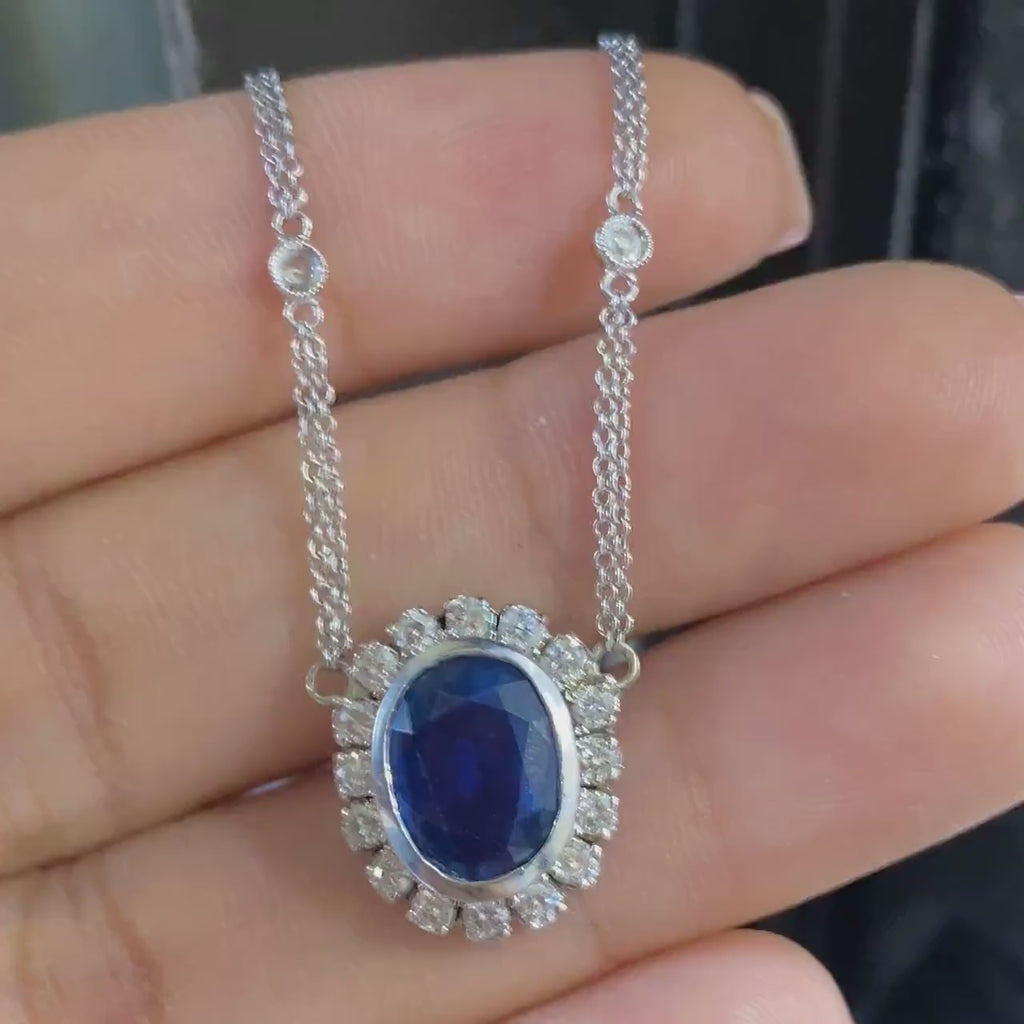 Oval blue sapphire with diamond pendant.