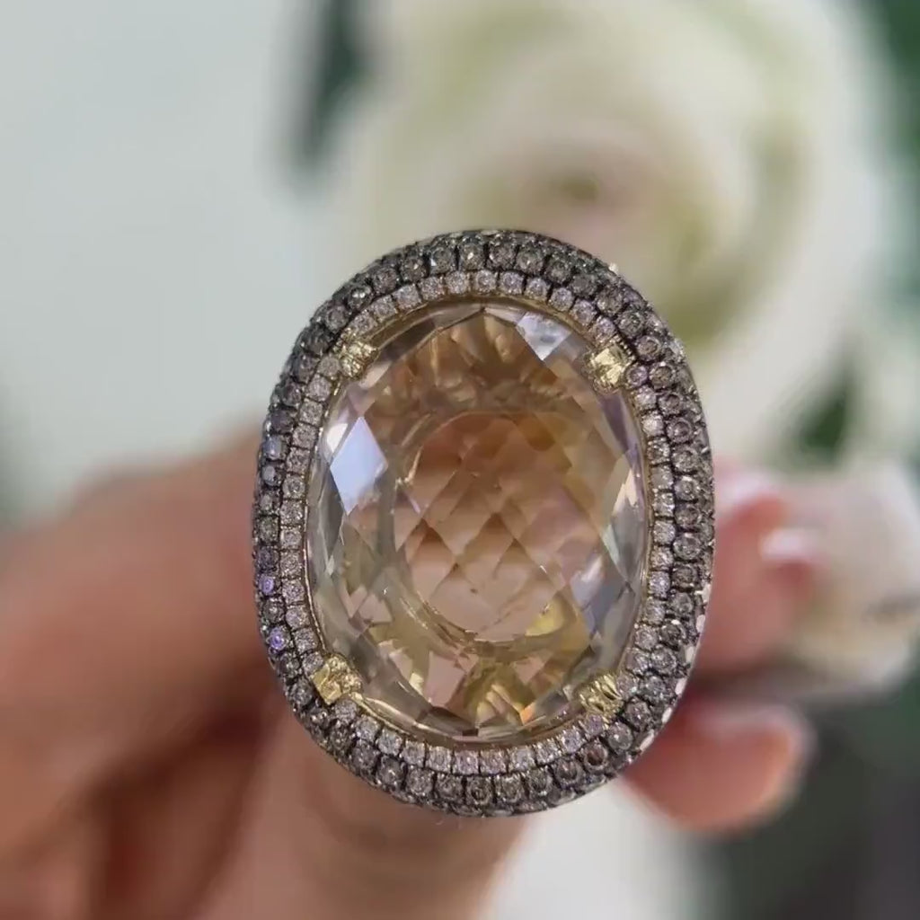 14Kt Yellow Gold Ring with an oval cut 19.32ct smoky topaz  0.31ct total in round cut white diamonds ,and 1.22ct total in champagne diamonds