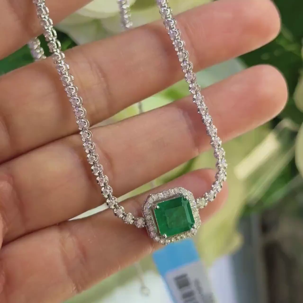 White Gold Three Quarter Diamond Tennis Necklace with Cushion Cut Emerald in a Halo Setting