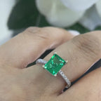 White Gold Compressed Green Emerald Ring Set in Prong Setting with Diamonds on Band