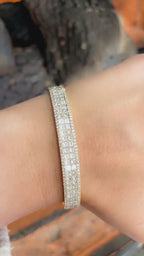 Yellow Gold Bangle with Princess and Round Cut Diamonds set in an Invisible Setting